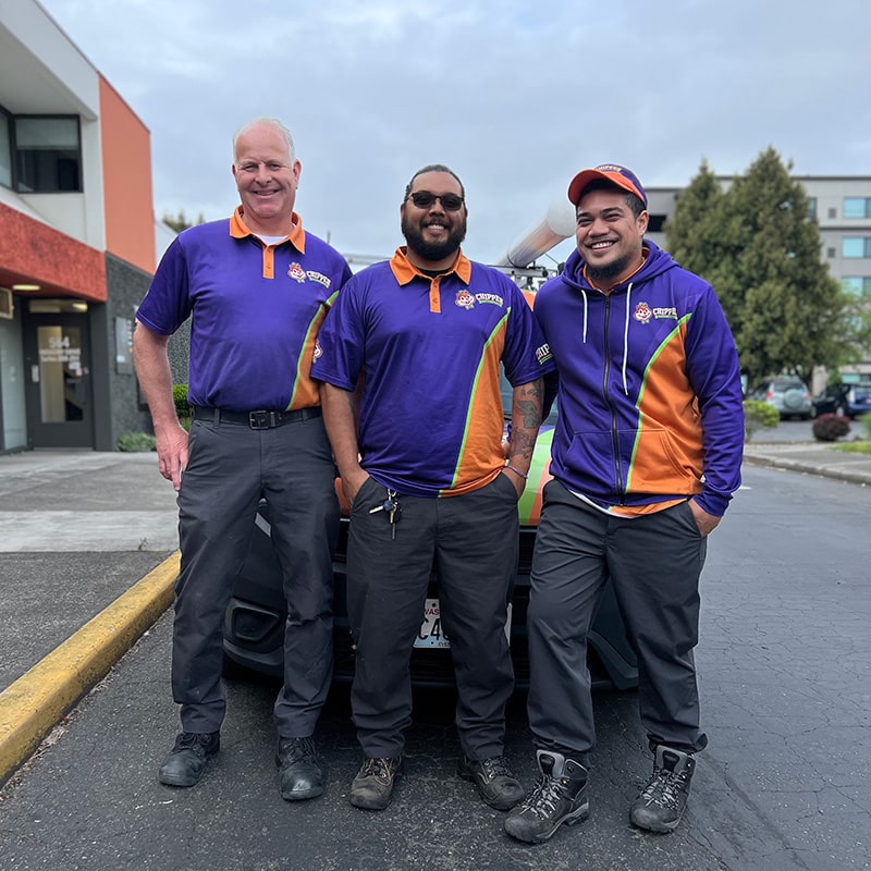 Three Chipper Plumbing & Radiant experts standing in front of the van