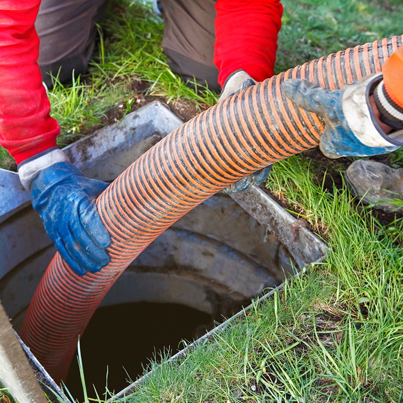 Chipper Plumbing & Radiant experts hold pipe cleaning a sewer line
